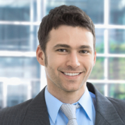 Portrait of happy businessman standing in office lounge smiling. Portrait of happy businessman standing in office lounge smiling.